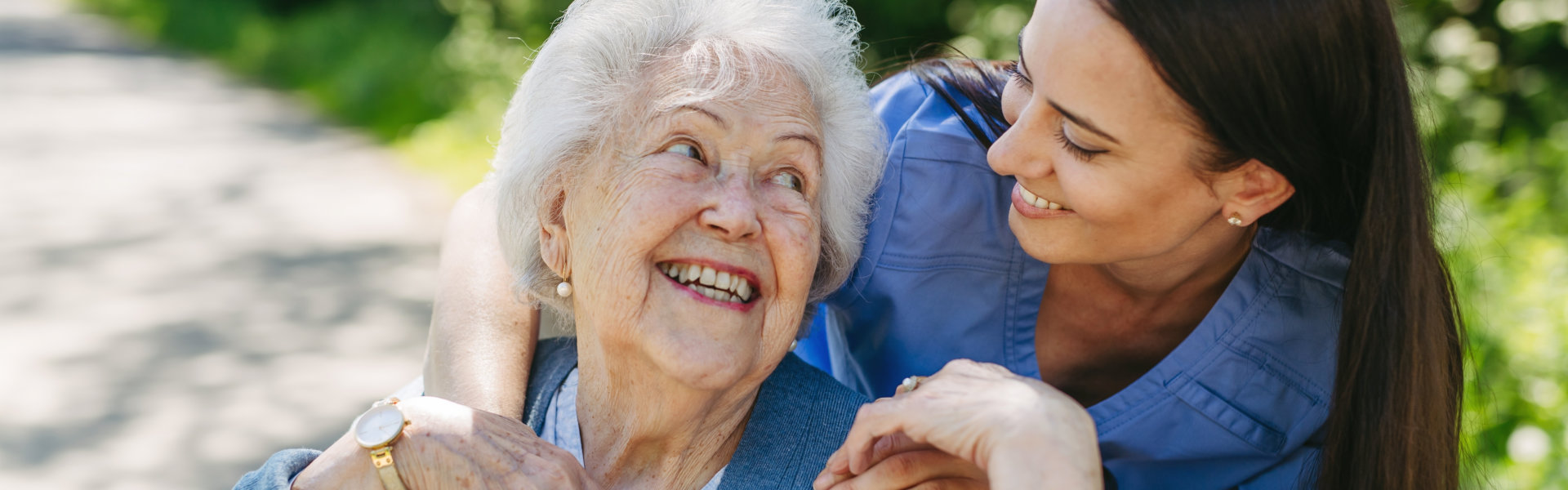 caregiver and senior woman smiling