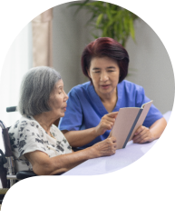 caregiver and senior woman reading a book