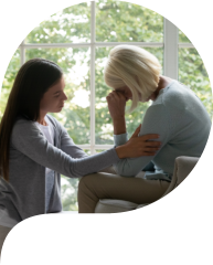 young woman comforting senior