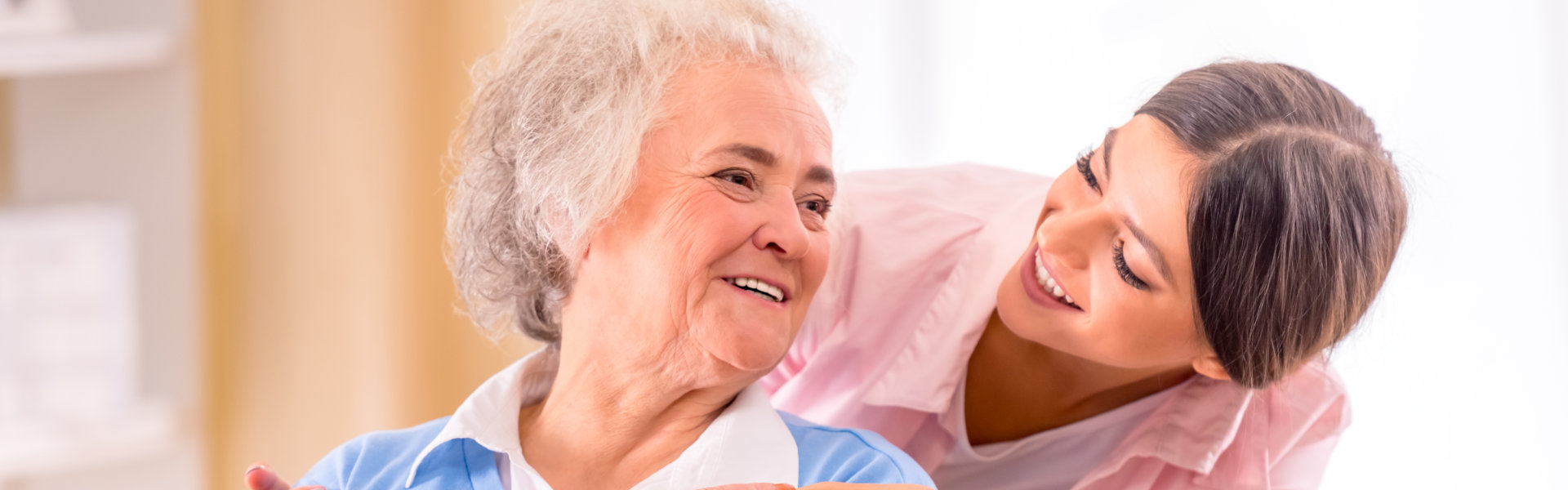 caregiver and senior smiling