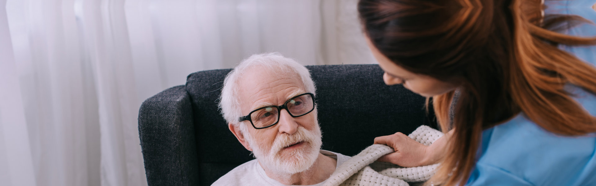 caregiver assisting senior man